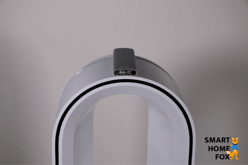 The remote control of the Dyson Pure Hot + Cool HP04 air purifier is magnetically attached to the oval tower of the appliance